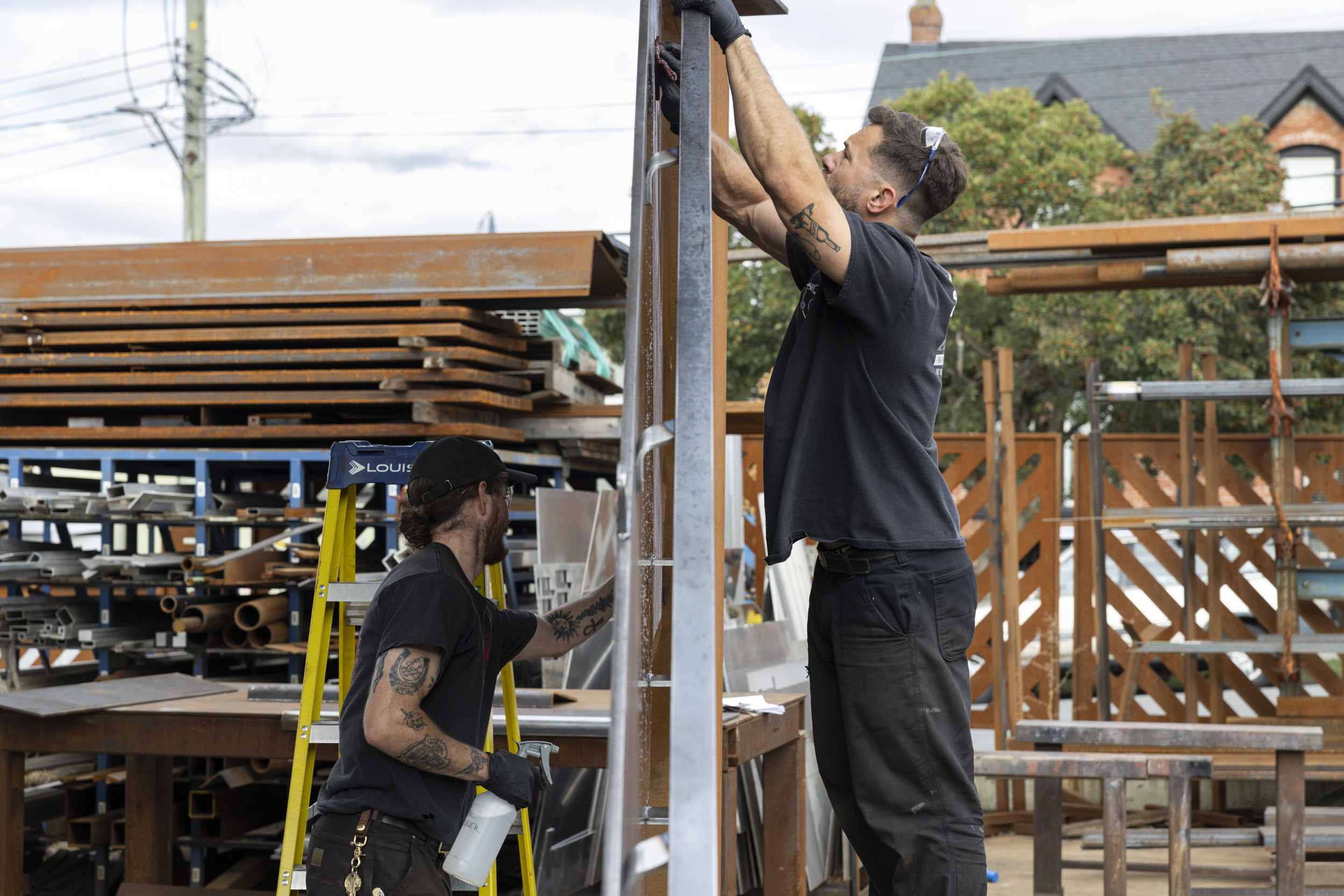Broadwell Metal two employees working on staircase in metal yard